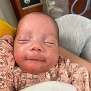 Mercedes joined the competition — help win amazing prizes! baby, newborn, infant, sleeping, face, closeup, onesie, floral_pattern, blanket, hand, arm, smile, rosy_cheeks, hospital_room, wood_panel, soft_lighting, cozy, parent_arm, portrait, peaceful