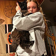 Angel joined the competition — help win amazing prizes! animal, black_cat, casual_clothing, cat, clock, cozy, domestic, furniture, gray_sweatshirt, home, hugging, indoor, jeans, long_hair, person, pet, portrait, staircase, warm_lighting, wooden_wall