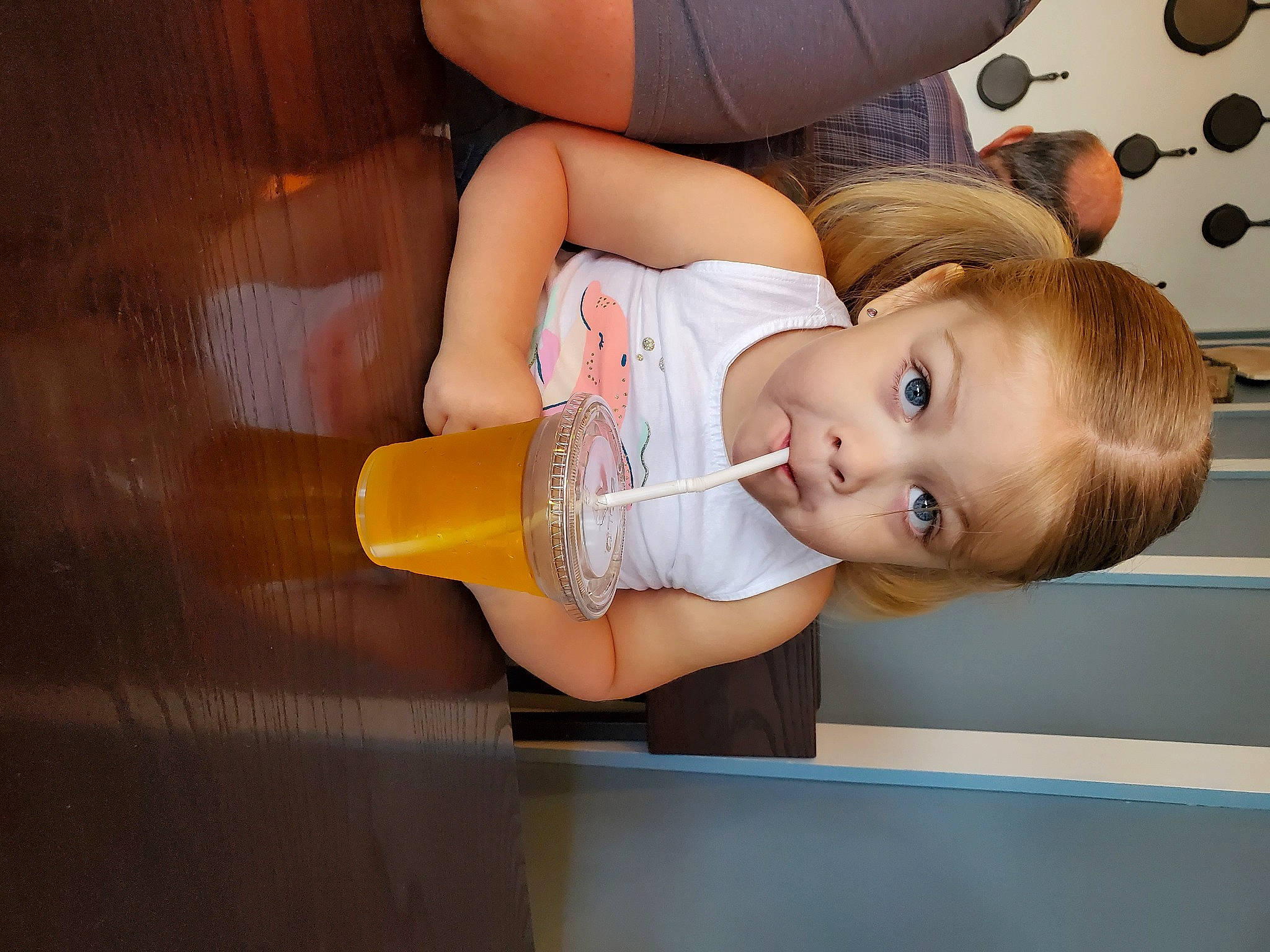 Madilynn is registered to the contest to win money with this photo: baby, baby_products, baby_toddler_clothing, child, dress, drinking, drinkware, eyelash, food, fun, happy, human_leg, nail, orange, person, plastic_bottle, skin, tableware, thigh, toddler