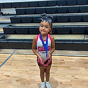 Sophia joined the competition — help win amazing prizes! athlete, award, bleachers, bow, cheerleader, child, competition, floor, gymnasium, indoor, medal, portrait, posing, smile, sport, sportswear, team, white_shoes, wooden_floor, young_girl