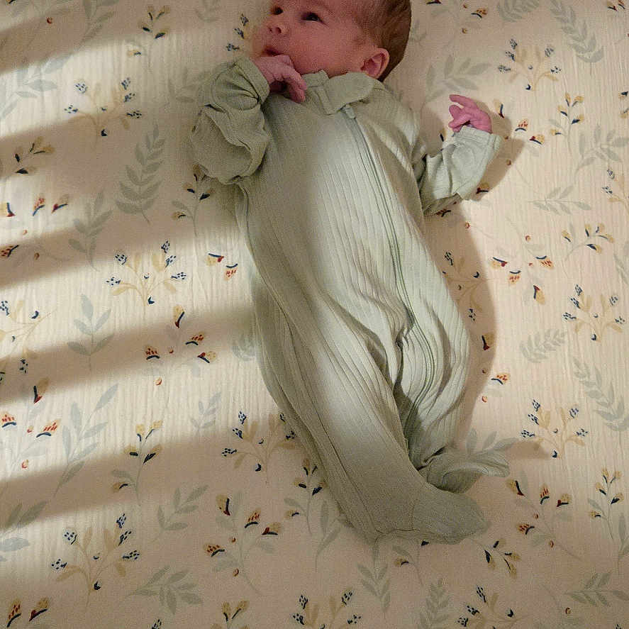 Jacob is registered to the contest to win money with this photo: baby, bed, bedroom, blanket, bodypart, clothing, crib, face, finger, furniture, glove, hand, head, indoors, infantbed, newborn, person, photography, portrait, room