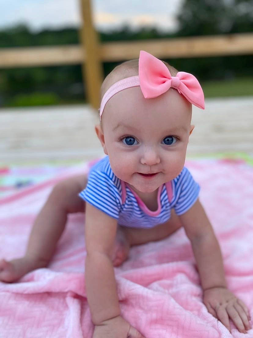 Nevaeh is registered to the contest to win money with this photo: baby, baby_toddler_clothing, cap, cheek, child, flooring, fun, grass, happy, hat, headwear, linens, magenta, person, pink, recreation, sitting, skin, sky, sleeve