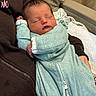 Davier joined the competition — help win amazing prizes! newborn, baby, sleeping, infant, portrait, face, closed_eyes, mint_green_outfit, onesie, blanket, carrier, cuddled, cozy, indoors, soft_lighting, peaceful, resting, sitting, parent, close_up