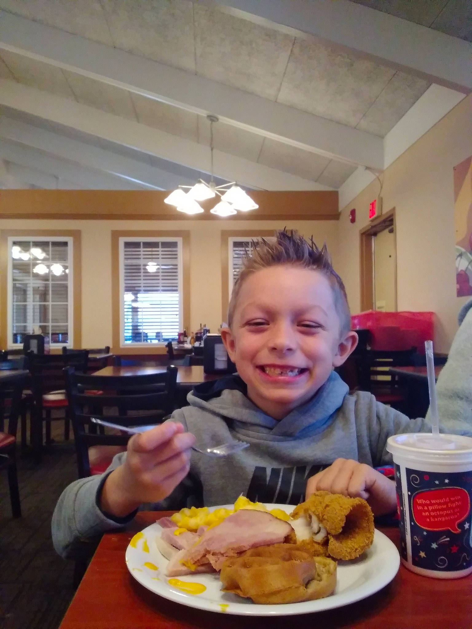 Tyler is registered to the contest to win money with this photo: chair, comfort_food, cuisine, dish, eating, fast_food, finger_food, food, food_craving, fried_food, ingredient, joy, junk_food, person, plate, recipe, smile, t_shirt, table, tableware