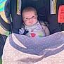 Valerie is registered to the contest to win money with this photo: baby, car_seat, blanket, polka_dot, blue_eyes, smile, bib, fruit_pattern, chicco, sunlight, outdoor, infant, cute, clothing, pacifier, seatbelt, child, person, happy, pink