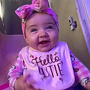 Leilani joined the competition — help win amazing prizes! baby, child, smiling, pink_bow, headband, bib, hello_cutie, pajamas, hello_kitty, indoor, person, happy, cute, infant, clothing, sitting, face, portrait, childhood, cozy