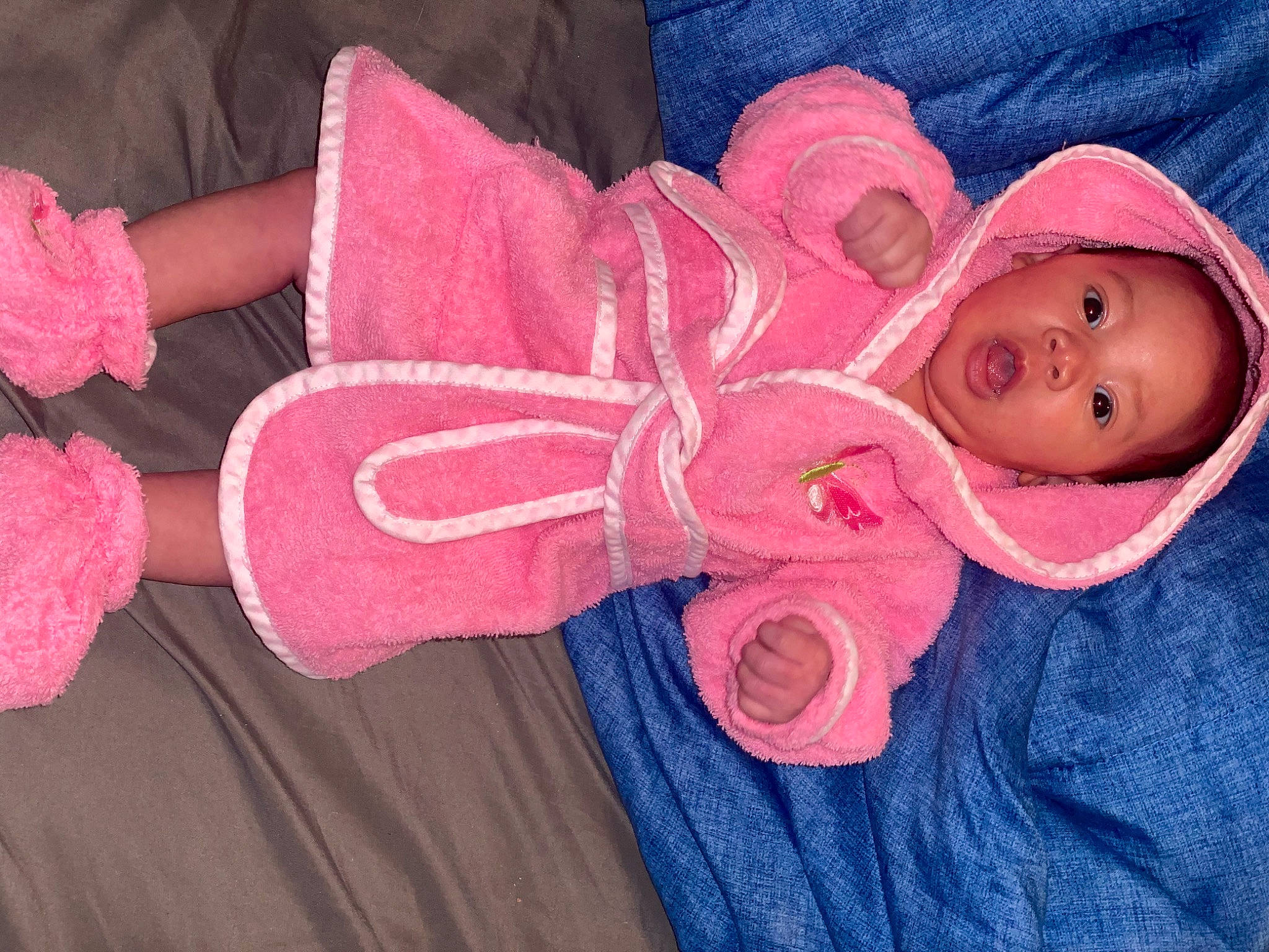 Jessica is registered to the contest to win money with this photo: arm, baby, baby_toddler_clothing, finger, hand, hat, human_body, leg, magenta, nail, outerwear, person, pink, red, skin, sleeve, smile, surprise, textile, toddler