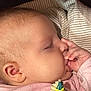 Penelope joined the competition — help win amazing prizes! baby, sleeping, thumb_sucking, close_up, blanket, pink_clothing, face, hand, ear, infant, peaceful, child, soft_texture, striped_blanket, portrait, cute, young_child, resting, indoors, newborn