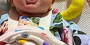Penelope joined the competition — help win amazing prizes! baby, laughing, blanket, polka_dot, floral_clothing, baby_seat, soft_toy, yellow_toy, pink_background, happy, infant, mouth_open, smiling, face, cheerful, child, cute, indoors, closeup, comfort