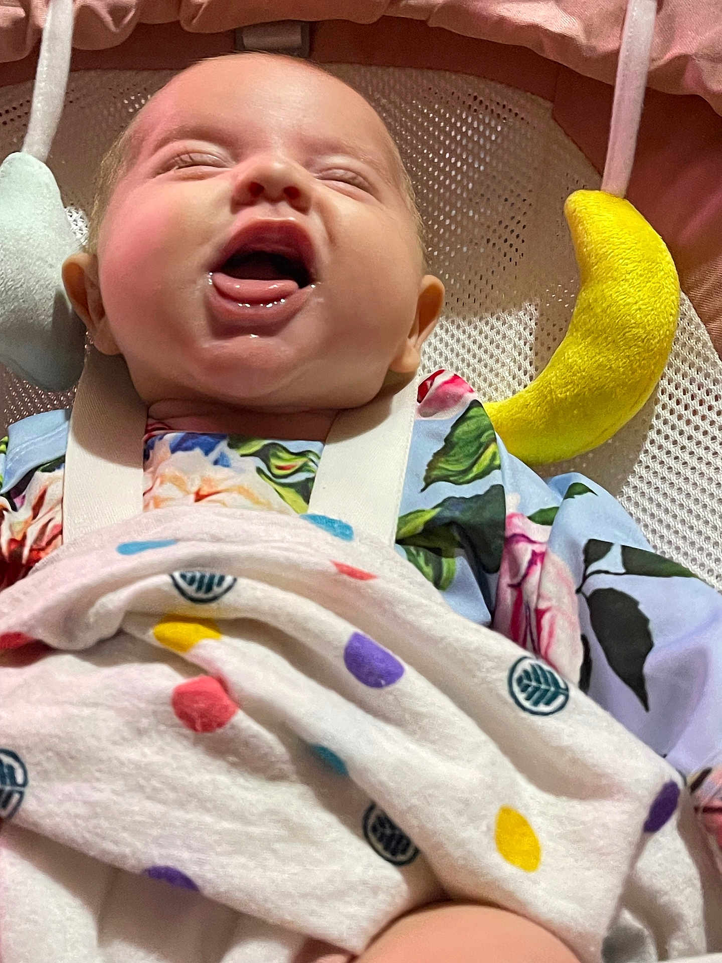 Penelope joined the competition — help win amazing prizes! baby, laughing, blanket, polka_dot, floral_clothing, baby_seat, soft_toy, yellow_toy, pink_background, happy, infant, mouth_open, smiling, face, cheerful, child, cute, indoors, closeup, comfort