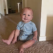 Roman joined the competition — help win amazing prizes! baby, child, infant, sitting, smiling, portrait, indoor, home, hallway, carpet, romper, clothing, face, eyes, happy, cute, floor, doorway, wall, photography
