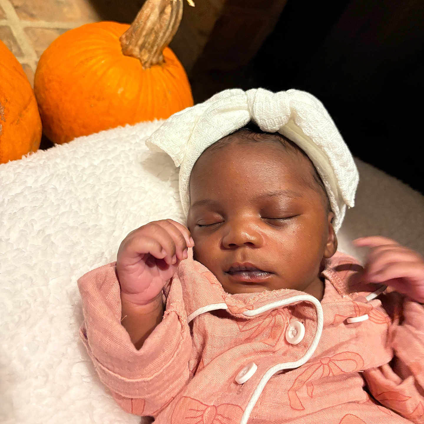 Jazylyn is registered to the contest to win money with this photo: autumn, baby, blanket, child, cozy, cute, face, hands, headband, indoor, infant, newborn, orange, peaceful, pink_clothing, portrait, pumpkin, resting, sleeping, soft_texture