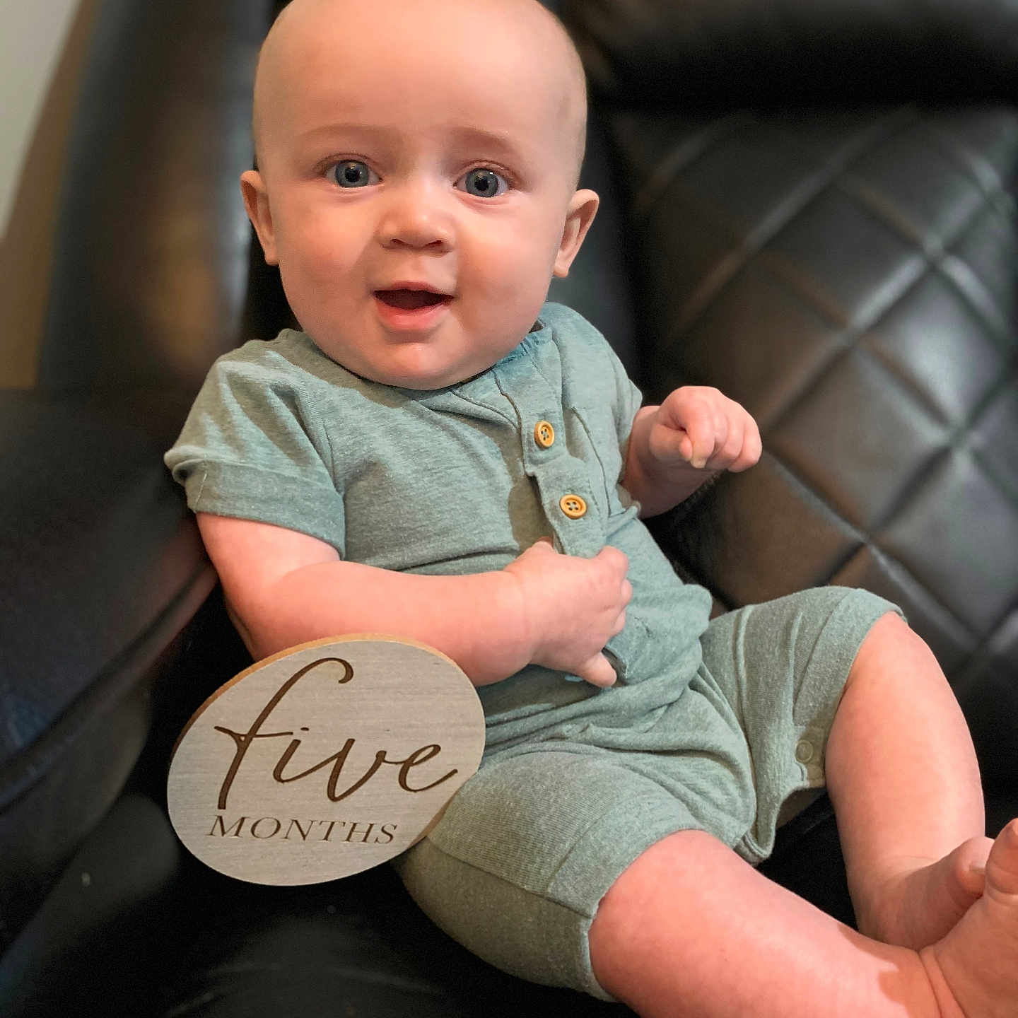 Bodhi is registered to the contest to win money with this photo: baby, bodypart, chair, clothing, couch, cushion, face, finger, furniture, hand, happy, head, homedecor, pants, person, photography, portrait, shorts, sitting, t_shirt