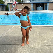 Dariahynis is registered to the contest to win money with this photo: child, girl, swimming_pool, bikini, playful, pose, outdoor, summer, water, poolside, lifeguard, concrete, blue, person, curly_hair, casual, daytime, fun, recreation, vacation