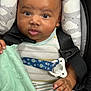 Misael is registered to the contest to win money with this photo: baby, infant, car_seat, blanket, face, hand, clothing, seatbelt, pacifier_clip, striped_clothing, cloud_pattern, child, cute, indoors, portrait, young_child, skin, expression, sitting, comfort