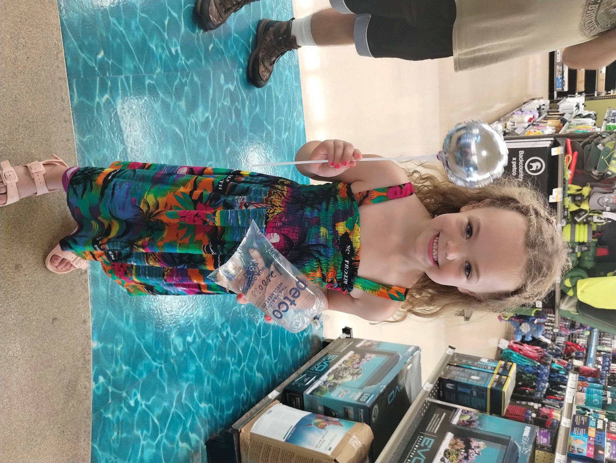 Lienna is registered to the contest to win money with this photo: child, collection, computer_hardware, eyewear, fashion_accessory, fun, human_leg, joy, machine, pattern, person, personal_protective_equipment, plastic, retail, room, smile, toddler, toy, visual_arts