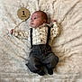 baby, infant, newborn, clothing, shirt, suspenders, pants, socks, blanket, soft_texture, wooden_sign, one_month, cute, lying_down, portrait, child, face, hand, feet, fabric
