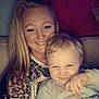 Maddox is registered to the contest to win money with this photo: woman, child, smiling, toddler, couch, indoor, portrait, happy, family, parent, childhood, cozy, casual, long_hair, blond_hair, clothing, hand, face, person, love