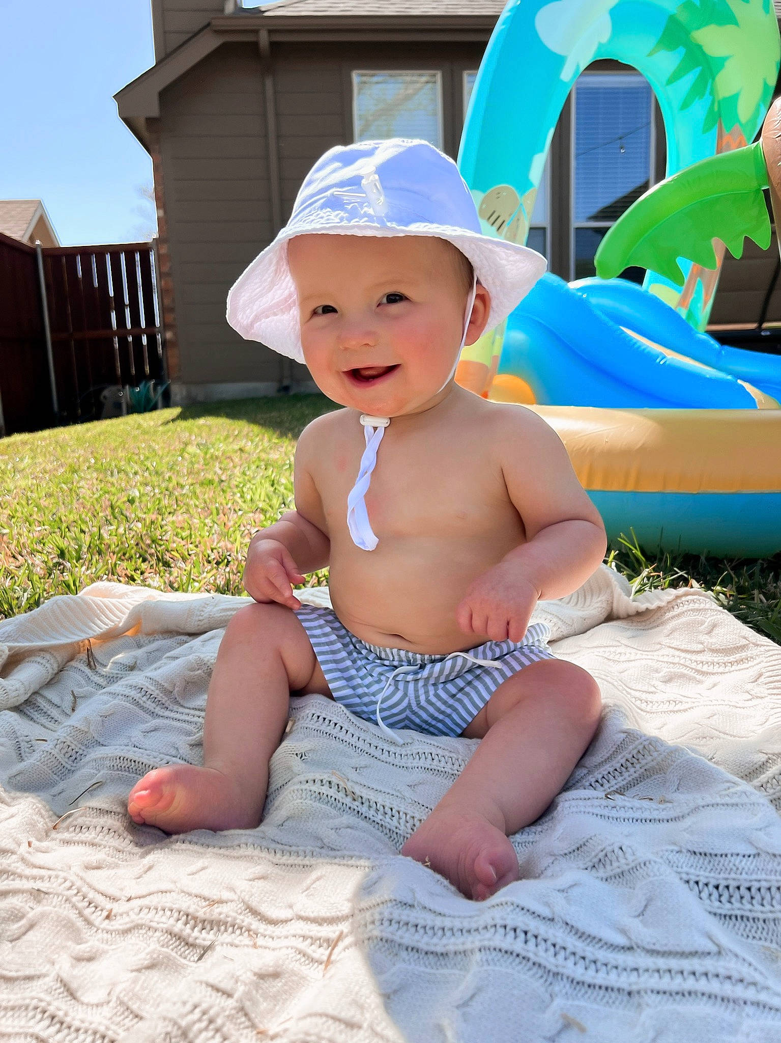 Graham joined the competition — help win amazing prizes! baby, baby_products, baby_toddler_clothing, blue, cap, child, fun, grass, happy, hat, headgear, headwear, joy, leisure, person, recreation, sitting, sky, smile, summer