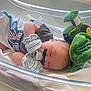 baby, newborn, sleeping, pacifier, mustache, mittens, hospital, bassinet, toy, plush, green, window, blanket, infant, cute, peaceful, resting, child, soft, light