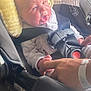baby, newborn, car_seat, infant, child, seatbelt, safety, hand, adult, yellow_headrest, clothing, cute, portrait, indoor, person, bonding, family, newborn_care, car, baby_carrier