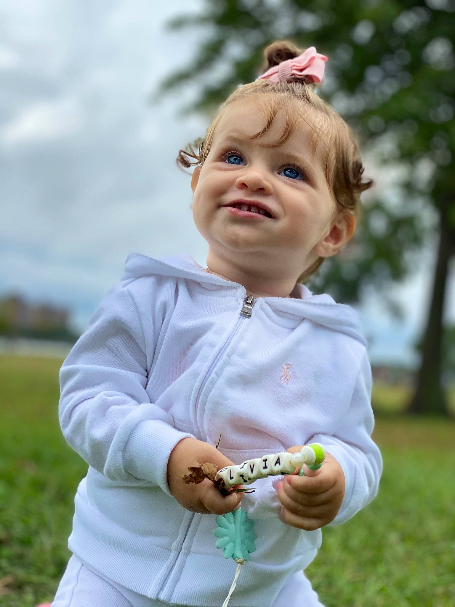 Olivia joined the competition — help win amazing prizes! baby_toddler_clothing, blond, child, fun, gesture, grass, grassland, hand, happy, joy, leisure, people_in_nature, person, pink, plant, play, recreation, sky, sleeve, spring