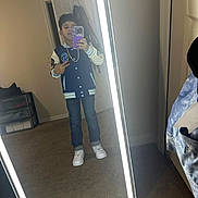 Yahir is registered to the contest to win money with this photo: child, boy, mirror, selfie, phone, peace_sign, jacket, jeans, sneakers, chain, carpet, indoor, room, door, furniture, reflection, lighting, casual, portrait, standing