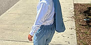 Yahir is registered to the contest to win money with this photo: child, boy, walking, sidewalk, outdoor, sunny, blue_suit, white_shirt, shoes, short_hair, confident, smile, looking_back, shadow, casual_pose, young, fashion, street, daytime, person