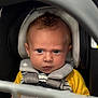 Riley is registered to the contest to win money with this photo: baby, car_seat, child, seatbelt, blue_eyes, serious_expression, infant, clothing, yellow_sleeves, striped_shirt, face, headrest, safety, portrait, indoor, closeup, person, young_child, baby_carrier, focus