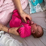 Ayla joined the competition — help win amazing prizes! baby, infant, child, pink_clothing, adult, hands, face, sleeping, lying_down, bed, blanket, pacifier, baby_wipes, diaper, changing, nursery, indoor, textile, caregiving, portrait