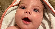 Evangeline is registered to the contest to win money with this photo: baby, bath, blanket, child, closeup, curl, cute, expression, eyes, face, happy, head, indoors, infant, newborn, open_mouth, person, skin, soft_texture, towel