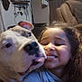 Kano joined the competition — help win amazing prizes! dog, child, smiling, indoor, living_room, recliner, television, close_up, affection, couch, curtains, person, pet, happy, tongue, hair, casual_clothing, wall, furniture, cute