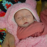 Olivia is registered to the contest to win money with this photo: baby, blanket, child, colorful, cozy, cradle, cute, fluffy, hand, hood, infant, pattern, person, pink, resting, sleeping, soft, toddler, warm, wearing
