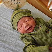 Callan joined the competition — help win amazing prizes! newborn, baby, infant, sleeping, hat, green_clothing, ribbed_fabric, blanket, soft, wooden_frame, peaceful, cute, small_hands, portrait, indoors, cozy, smile, baby_clothes, lying_down, closeup