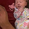 Dakota is registered to the contest to win money with this photo: newborn, baby, sleeping, pacifier, onesie, colorful, infant, arm, hand, face, adult, resting, cute, closeup, bed, blanket, soft, tender, peaceful, indoor