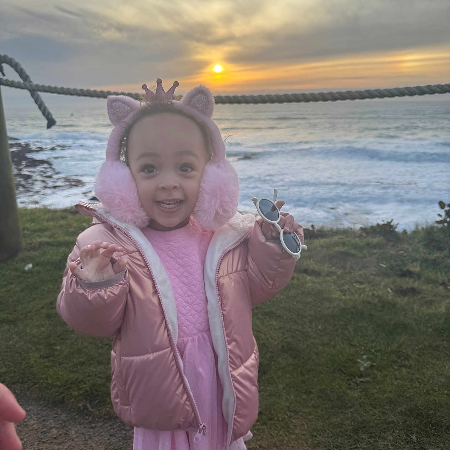 Melody is registered to the contest to win money with this photo: beach, child, clothing, coast, coat, face, female, girl, hat, head, hood, jacket, nature, outdoors, person, photography, portrait, sky, water, waterfront
