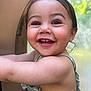 toddler, child, smiling, happy, face, eyes, teeth, hair, arm, skin, clothing, sleeveless, playground, background_blur, outdoor, daylight, nature, greenery, portrait, closeup