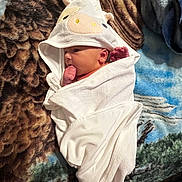 John joined the competition — help win amazing prizes! baby, infant, towel, animal_hood, blanket, patterned_blanket, sucking_thumb, wrapped, cute, newborn, lying_down, white_towel, soft_texture, indoors, face, head, small_hands, cozy, resting, child