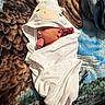 baby, infant, towel, animal_hood, blanket, patterned_blanket, sucking_thumb, wrapped, cute, newborn, lying_down, white_towel, soft_texture, indoors, face, head, small_hands, cozy, resting, child
