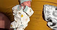 John joined the competition — help win amazing prizes! baby, bed, blanket, child, clothing, cozy, cute, fabric, hat, indoors, infant, newborn, pacifier, pajamas, peaceful, portrait, resting, sleeping, soft, yellow