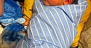 John joined the competition — help win amazing prizes! newborn, baby, wrapped, blanket, striped_blanket, blue_blanket, yellow_pillow, soft_toys, sleeping_area, infant, cozy, resting, cute, child, face, indoors, portrait, warm_colors, soft_texture, peaceful