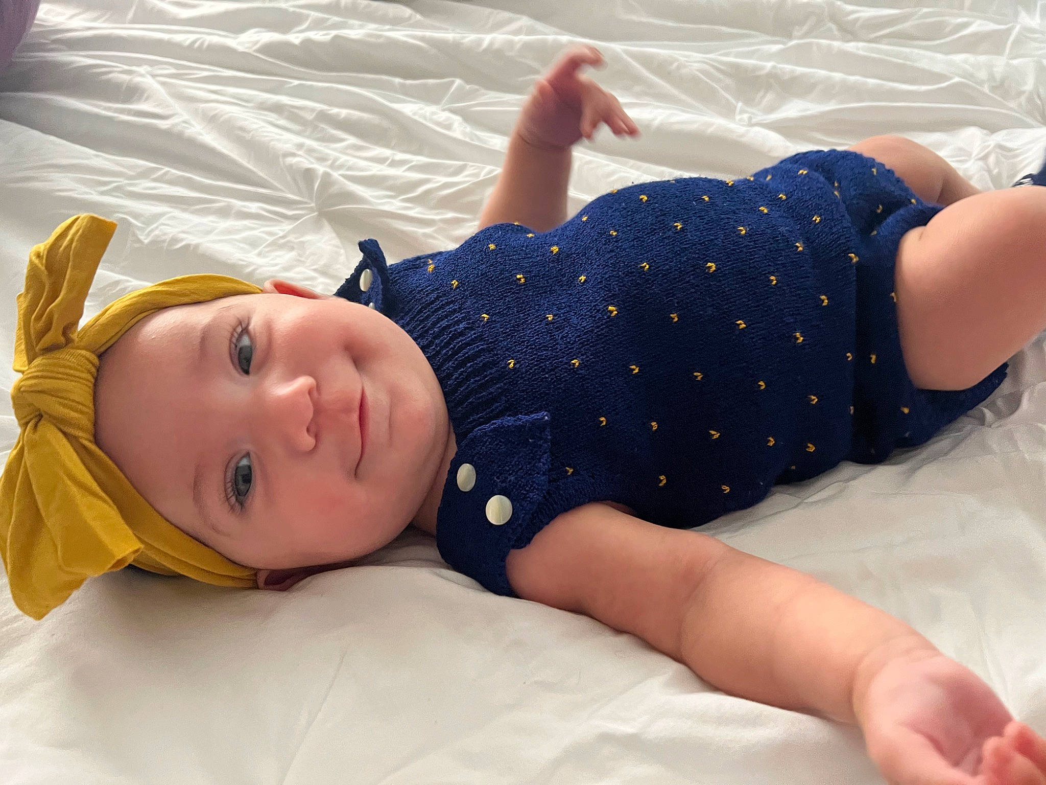 Ariella joined the competition — help win amazing prizes! baby, baby_toddler_clothing, bedding, child, comfort, elbow, happy, hat, headwear, human_leg, knee, leisure, linens, pattern, person, product, room, sitting, sleeve, smile