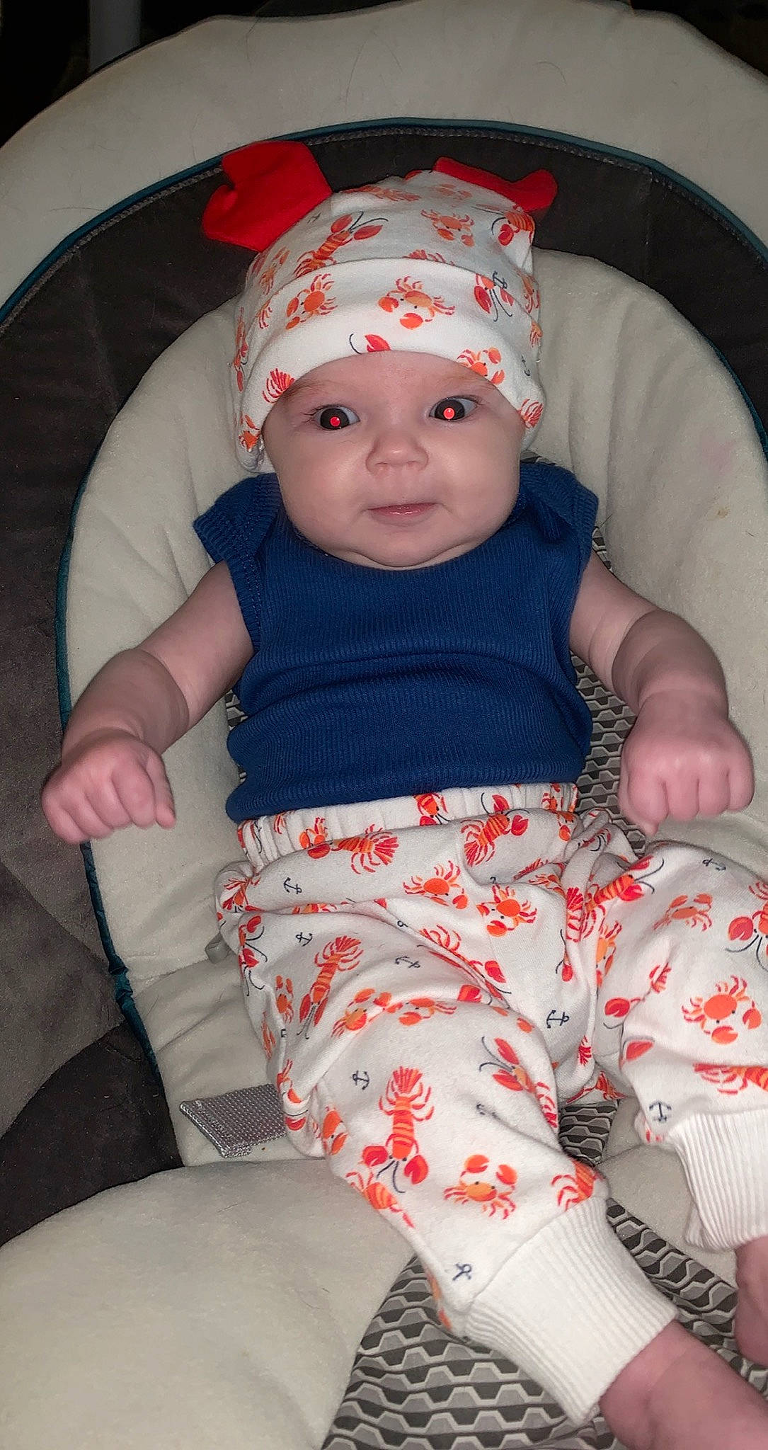 Scarlett is registered to the contest to win money with this photo: baby, baby_toddler_clothing, baseball_cap, cap, chair, cheek, child, comfort, headgear, headwear, lap, organ, pattern, person, pink, product, red, skin, sleeve, sock