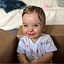 Iris a rejoint le concours — aidez-le/la à gagner de superbes lots ! baby, blue_eyes, bright, cardboard_box, casual_clothing, child, closeup, cute, happy, indoor, infant, person, playful, portrait, short_hair, sitting, smile, toddler, white_shirt, young_child