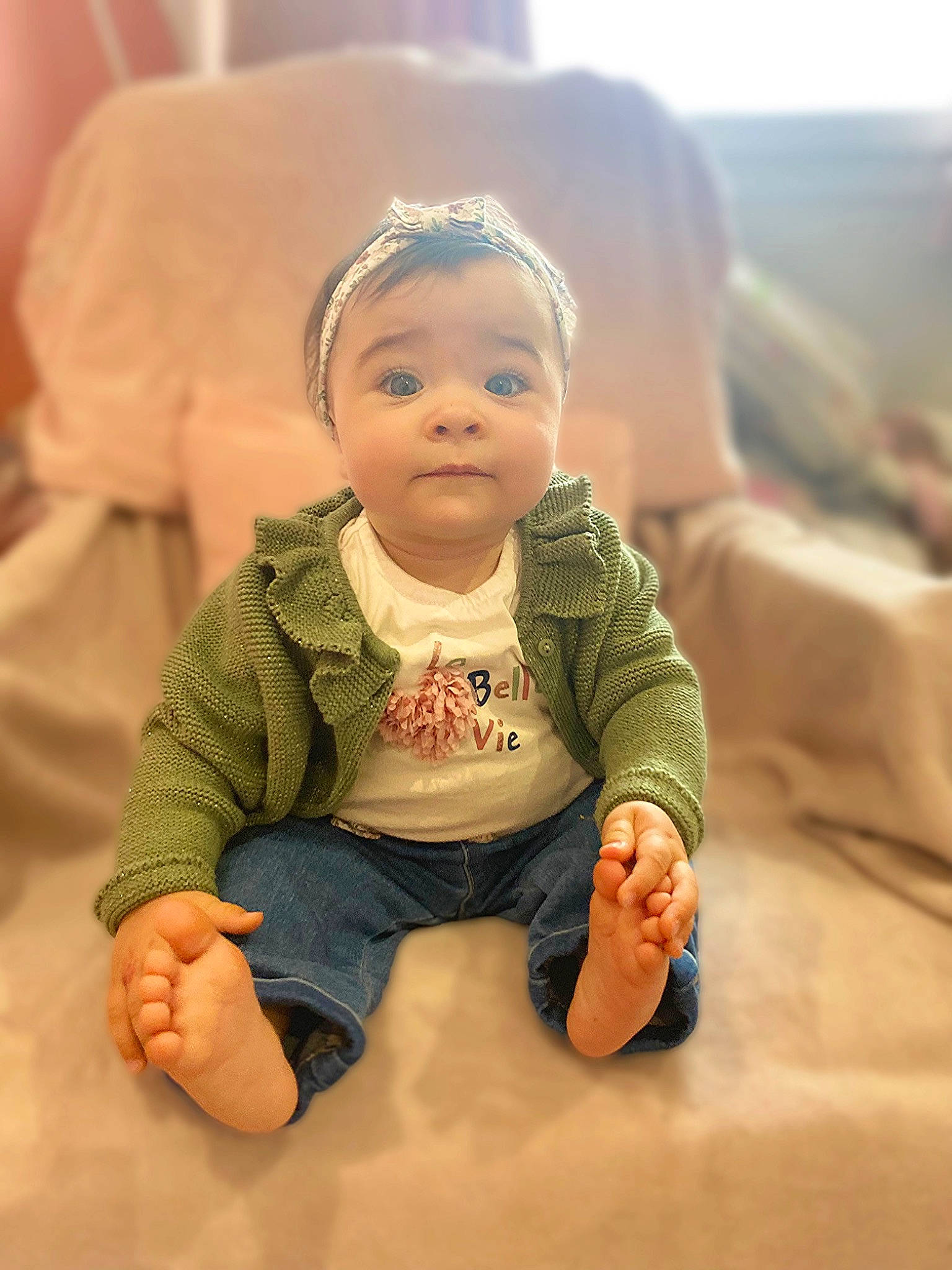 Mia participe au concours pour gagner de l'argent avec cette photo : baby, baby_toddler_clothing, cheek, child, chin, comfort, eye, finger, flash_photography, floor, flooring, foot, happy, nose, person, sitting, skin, sleeve, smile, toddler