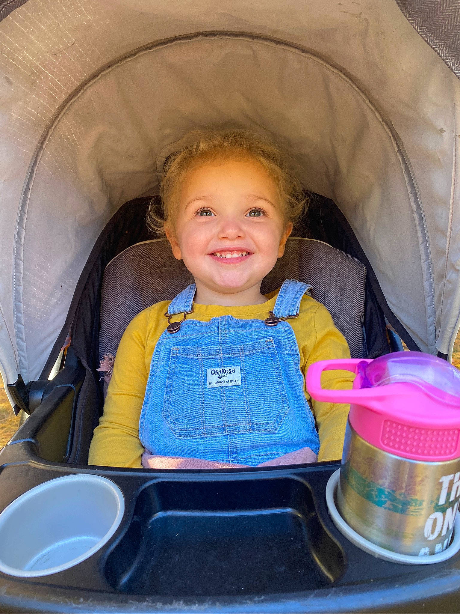 Evie is registered to the contest to win money with this photo: auto_part, automotive_design, child, comfort, electric_blue, eye, fun, joy, leisure, material_property, motor_vehicle, organ, person, product, recreation, sitting, smile, snapshot, tent, toddler