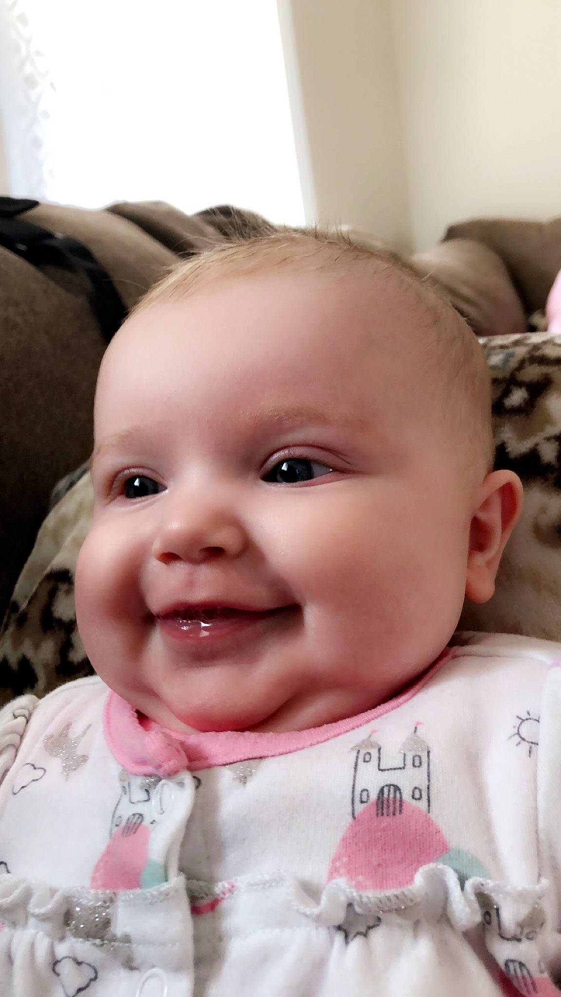 Evie is registered to the contest to win money with this photo: baby, baby_making_funny_faces, cheek, child, chin, close_up, ear, eye, face, facial_expression, forehead, head, joy, lip, mouth, nose, person, pink, skin, smile