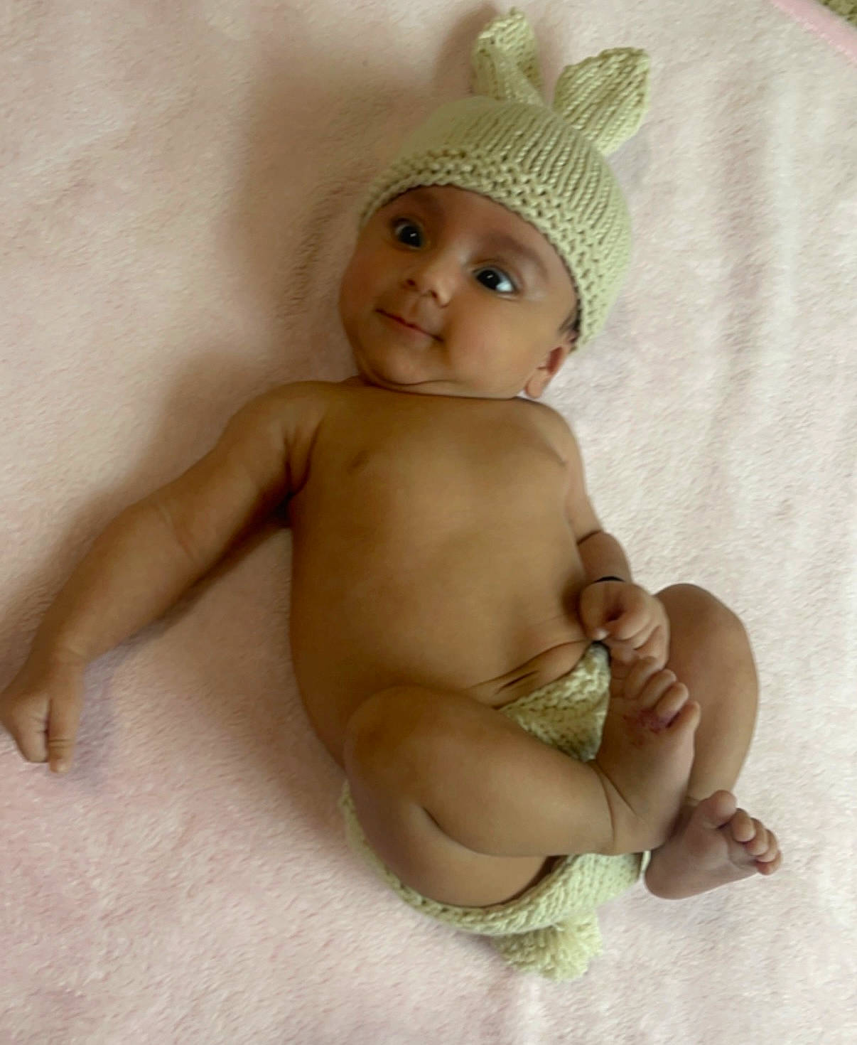 Helena is registered to the contest to win money with this photo: abdomen, baby, baby_toddler_clothing, cap, chest, eyebrow, finger, happy, headband, headgear, headpiece, headwear, human_leg, iris, person, skin, smile, stomach, thigh, thumb