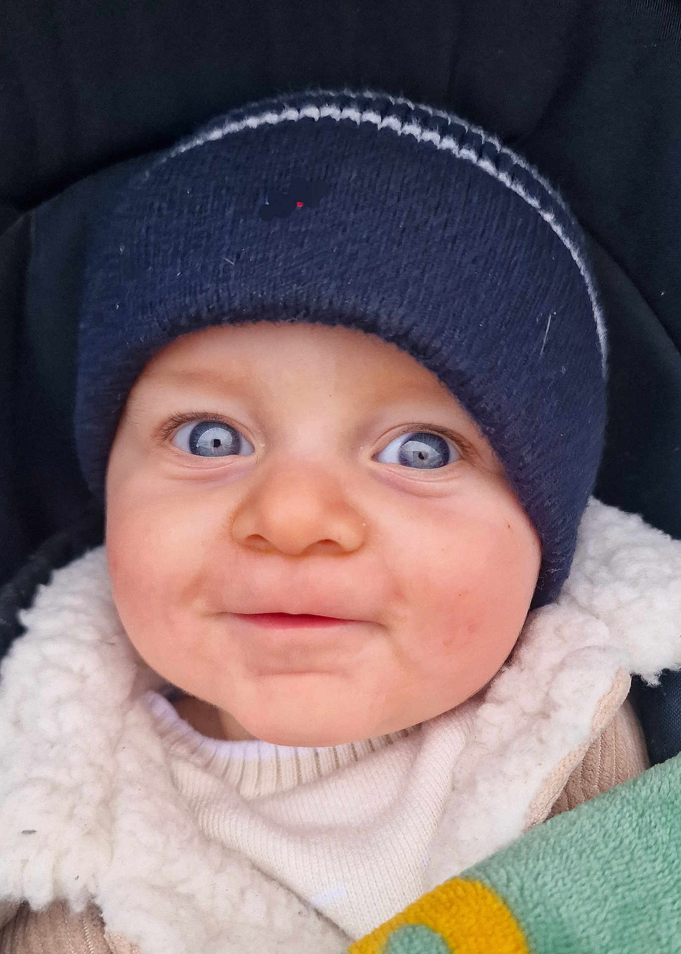 Kameron participe au concours pour gagner de l'argent avec cette photo : baby, child, face, blue_eyes, hat, knit_hat, jacket, coat, blanket, closeup, cute, infant, warm_clothing, portrait, outdoor, smile, person, young_child, apparel, headwear