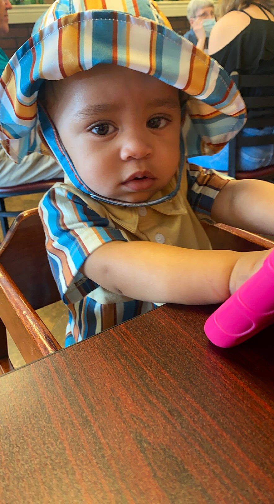 King is registered to the contest to win money with this photo: baby, baby_toddler_clothing, cap, child, electric_blue, eye, facial_expression, fashion_accessory, flooring, fun, grass, happy, headwear, human, leisure, person, recreation, sitting, skin, toddler